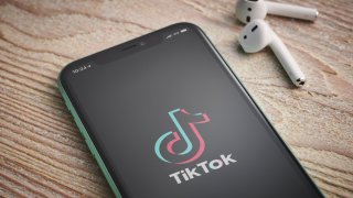 An Apple iPhone 11 smartphone with the TikTok video sharing app logo