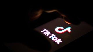 In this photo illustration, a TikTok logo is seen displayed on a smartphone.