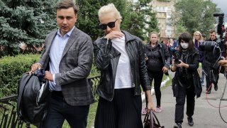 Alexei Navalny's wife Yulia, center, and Navalny's colleague Ivan Zhdanov, left, arrive to the Omsk Ambulance Hospital No. 1, intensive care unit where Alexei Navalny was hospitalized in Omsk, Russia, Friday, Aug. 21, 2020.