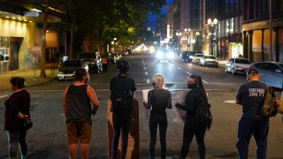 A line of protesters blocks the street in front of the Mark O. Hatfield U.S. Courthouse during a Black Lives Matter protest on August 2, 2020 in Portland, Oregon.