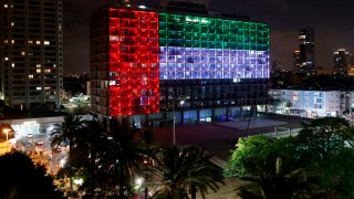 The city hall in the Israeli coastal city of Tel Aviv is lit up in the colors of the United Arab Emirates national flag on August 13, 2020