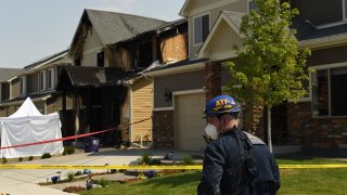 Officials investigate a house fire, at 5312 Truckee St., after five people were killed inside on August 5, 2020 in Denver, Colorado.