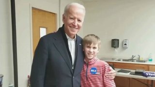 Democratic presidential nominee Joe Biden poses with Brayden Harrington, a New Hampshire boy. Harrington, who has a stutter, says Biden has been a role model to him.