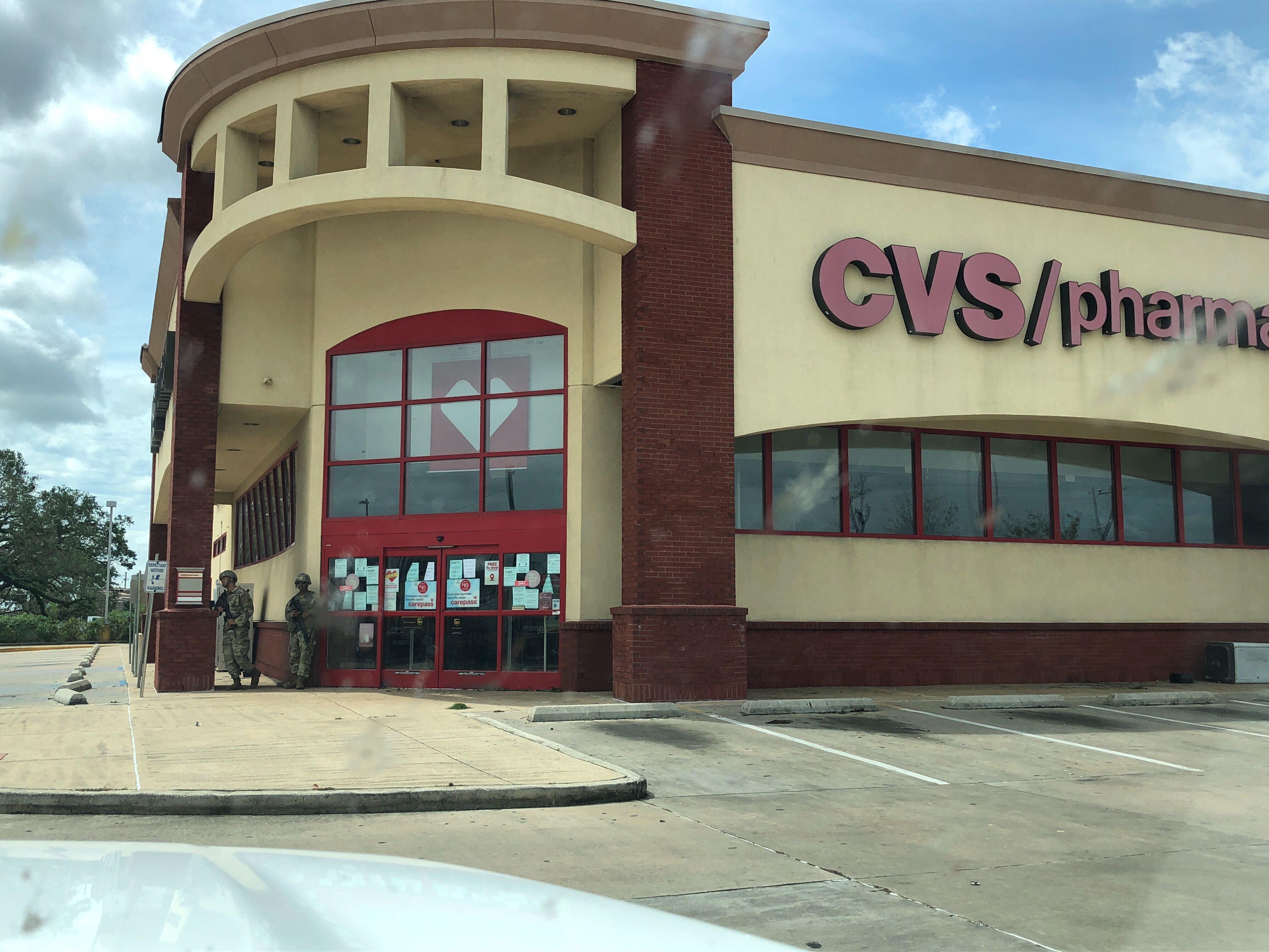 Lake Charles damage.    Army National Guard guarding a CVS.