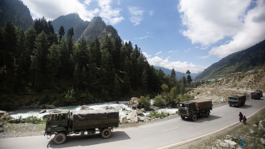 FILE - In this Tuesday, Sept. 1, 2020, file photo, an Indian army convoy moves on the Srinagar- Ladakh highway at Gagangeer, northeast of Srinagar, Indian-controlled Kashmir. As the escalating and bitter military standoff between India and China protracts following their bloodiest confrontation in decades in the Ladakh region in 2020, experts warn the two nuclear-armed countries can unintentionally slide into a war over the roof of the world. The two most populous nations share thousands of kilometers (miles) disputed border and have accused each other for opening new fronts.