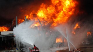 Firefighters work to extinguish a fire at warehouses at the seaport in Beirut, Lebanon, Thursday, Sept. 10. 2020. A huge fire broke out Thursday at the Port of Beirut, triggering panic among residents traumatized by last month's massive explosion that killed and injured thousands of people.