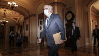 In this Sept. 30, 2020, file photo, Senate Majority Leader Mitch McConnell, a Republican from Kentucky, wears a protective mask while walking to the senate floor as Amy Coney Barrett, U.S. President Donald Trump's nominee for associate justice of the U.S. Supreme Court, not pictured meets with senators at the U.S. Capitol in Washington, D.C.