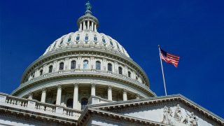 WASHINGTON, UNITED STATES - JANUARY 01: The stars and stripes flag flying at the Capitol Building, Washington, USA.