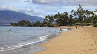 People visit a beach in Kihei, Maui County, Hawaii.