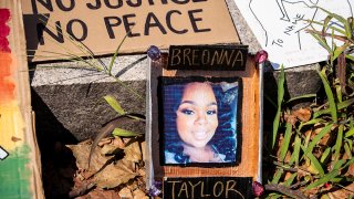 A sign with a picture of Breonna Taylor lays aside the path of a march at Cadman Plaza in Brooklyn, July 25, 2020.