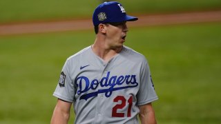 Los Angeles Dodgers starting pitcher Walker Buehler celebrates the end of the third inning against the Tampa Bay Rays in Game 3 of the baseball World Series Friday, Oct. 23, 2020, in Arlington, Texas.