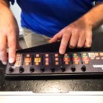 A man with his hands on a small electronic button controller