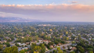 In this September 2020 file photo, smoke from the Cameron Peak Fire casts a smoky sky over Fort Collins, Colorado. The fire has become the largest in the state's history.