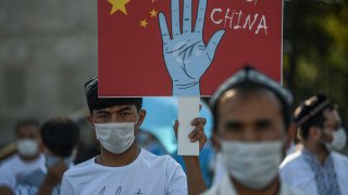Supporters of China's Muslim Uyghur minority wave flags of East Turkestan and hold placards as they gather at the Beyazid square on October 1, 2020 during a demonstration to protest China's Uighur treatment in Istanbul.