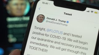 Photo illustration showing a tweet by president Donald Trump saying he and his wife have coronavirus