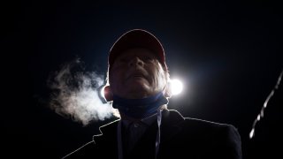 A man watches as President Donald Trump speaks during a Make America Great Again rally