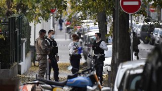 Security and emergency personnel on scene where an attacker armed with a sawn-off shotgun shot and wounded an Orthodox priest before fleeing on Oct. 31, 2020, in Lyon, France.