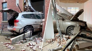 A silver vehicle crashed through the exterior of a downtown D.C. building, plowing through bricks and drywall before coming to rest halfway inside.
