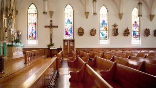 Pews and stained glass windows in church