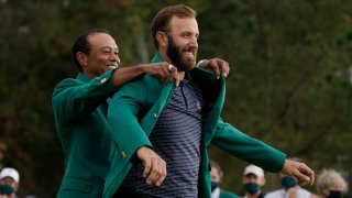 Tiger Woods helps Masters' champion Dustin Johnson with his green jacket