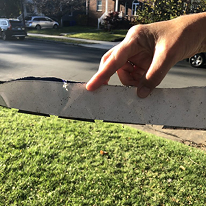 Razor blades found on the bottom of a political sign.