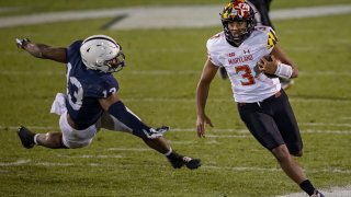 Taulia Tagovailoa avoids Ellis Brooks of the Penn State Nittany Lions during the second half at Beaver Stadium Nov. 7, 2020, in State College, Pennsylvania.