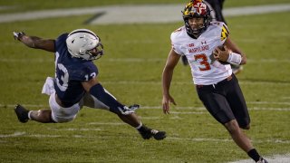 Taulia Tagovailoa avoids Ellis Brooks of the Penn State Nittany Lions during the second half at Beaver Stadium Nov. 7, 2020, in State College, Pennsylvania.