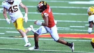 Taulia Tagovailoa runs with the ball against the Minnesota Golden Gophers. (Photo by Mitchell Layton/Getty Images)