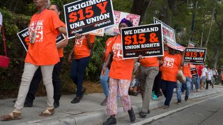 People gather together to ask the McDonald’s corporation to raise workers wages to a $15 minimum wage as well as demanding the right to a union on May 23, 2019 in Fort Lauderdale, Florida.