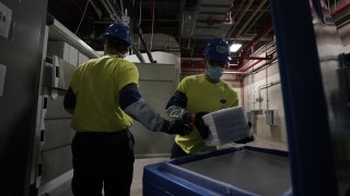 Boxes containing the Pfizer-BioNTech Covid-19 vaccine are prepared to be shipped at the Pfizer Global Supply Kalamazoo manufacturing plant in Kalamazoo, Michigan on December 13, 2020.