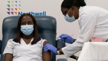 Sandra Lindsay, left, a nurse at Long Island Jewish Medical Center, becomes one of the first Americans inoculated with the COVID-19 vaccine on Dec. 14, 2020, Queens, New York