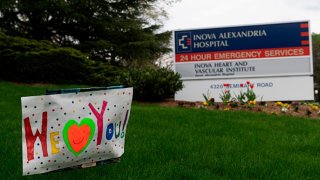 A sign of support for health care workers dealing with the COVID-19, pandemic adorns the entrance to INOVA Hospital in Alexandria, Virginia on April 7, 2020. (Photo by ANDREW CABALLERO-REYNOLDS / AFP)