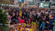 Mourners gather around a makeshift memorial for Kobe Bryant in front of the Staples Center in Los Angeles, Jan. 26, 2020.