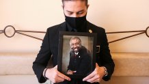 Jorge Ortiz, general manager of Perches Funeral Homes, displays a photo of deceased colleague Bishop Harrison Johnson on Nov. 14, 2020 in El Paso, Texas. Texas eclipsed one million COVID-19 cases on November 11th, with El Paso holding the most cases statewide.