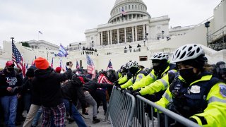 Trump supporters try to break through a police barrier, Wednesday, Jan. 6, 2021, at the Capitol in Washington.