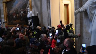TOPSHOT – Supporters of US President Donald Trump protest in the US Capitol’s Rotunda on January 6, 2021, in Washington, DC. – Demonstrators breeched security and entered the Capitol as Congress debated the a 2020 presidential election Electoral Vote Certification. (Photo by Saul LOEB / AFP) (Photo by SAUL LOEB/AFP via Getty Images)