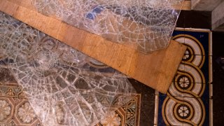 Broken glass lay on the floor inside the U.S. Capitol in Washington D.C., Jan. 6, 2021. The House and Senate resumed a politically charged debate over the legitimacy of the presidential election hours after a pro-Trump mob stormed the U.S. Capitol and drove lawmakers from their chambers.