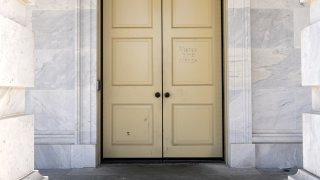"Murder The Media" is written on the doors of the U.S. Capitol