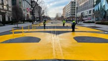 Workers repaint the BLM letters at Black Lives Matter Plaza in Washington, DC, on January 15, 2021. (Photo by Daniel SLIM / AFP)