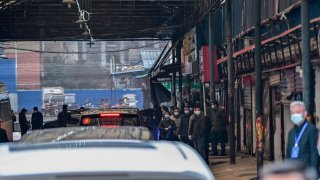 Cars transporting members of the World Health Organization (WHO) team, investigating the origins of the Covid-19 coronavirus, arrive at the closed Huanan Seafood wholesale market in Wuhan, China's central Hubei province on January 31, 2021.