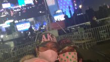 Karyn Upshaw, closest to the camera in a pink beanie, and Debbie-Anne Reese, wearing a pink mask with green dots, support their line sister Kamala Harris when she and Joe Biden announce their presidential win in Wilmington, DE.