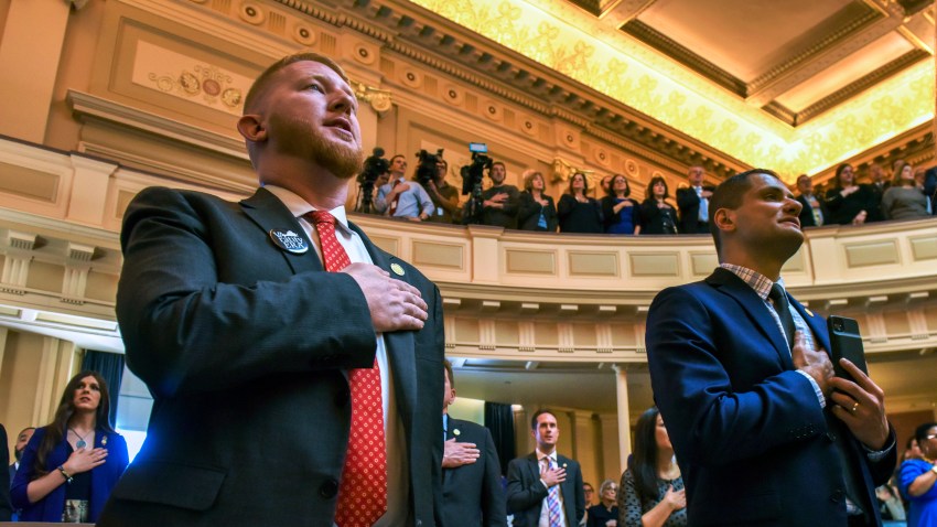 Two men hold their right hands over their hearts for the pledge of allegiance