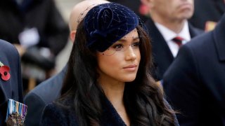 In this Nov. 7, 2019 file photo, Meghan the Duchess of Sussex stands after she and her husband Britain's Prince Harry placed a Cross of Remembrance as they attend the official opening of the annual Field of Remembrance at Westminster Abbey in London.