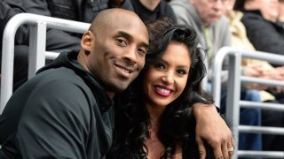 In this March 9, 2016, file photo, Los Angeles Lakers Guard Kobe Bryant and his wife Vanessa Bryant pose for a photo during a game between the Los Angeles Kings and the Washington Capitals at STAPLES Center in Los Angeles, California.