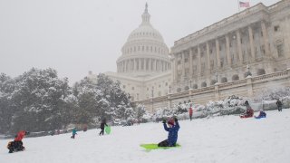 Children sled at the US Capitol during a snow storm in Washington, DC, March 21, 2018. (Photo credit should read SAUL LOEB/AFP via Getty Images)