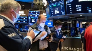 Traders work on the floor of the New York Stock Exchange.
