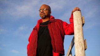 Lateef Dowdell stands on land once belonging to his uncle Gil Alexander, who was the last active Black farmer in the community of Nicodemus, Kan., Thursday, Jan. 14, 2021. Dowdell moved back to Nicodemus, a settlement founded by former slaves known as "exodusters" in the 1870s, several years earlier to take over the farm after his uncle died, but soon after lost most of the land when the bank foreclosed. New legislation in Congress aims to remedy historical inequities in government farm programs that have helped reduce the number of Black farmers in the United States from about a million in 1920 to less than 50,000 today.