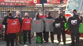 First responders accept swag from the Washington Nationals.