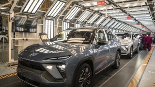 Employees make checks at an inspection line during a media tour of the Nio Inc. production facility in Hefei, Anhui province, China, on Friday, Dec. 4, 2020.