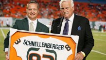 MIAMI GARDENS, FL - AUGUST 30: University of Miami Athletic Director Blake James presents a football jersey to Howard Schnellenberger prior to the game between the Miami Hurricanes and the Florida Atlantic Owls on August 30, 2013 at Sun Life Stadium in Miami Gardens, Florida. Schnellenberger was the Miami head coach when they won their 1983 national championship going 11-1 and defeating Nebraska in the championship game at the Orange Bowl. Miami defeated Florida Atlantic 34-6. (Photo by Joel Auerbach/Getty Images)